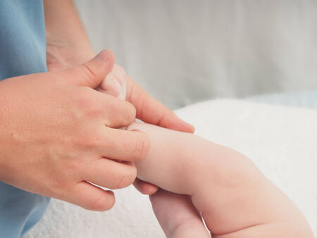 Baby massage doctor massage small caucasian baby boy fingersの写真素材