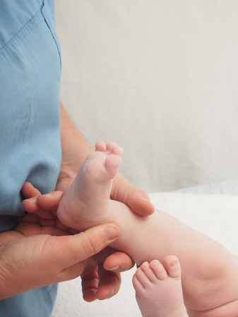 Baby massage doctor massage small caucasian baby boy footの写真素材