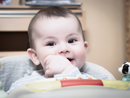 Portrait of smiling caucasian baby boy at homeの写真素材