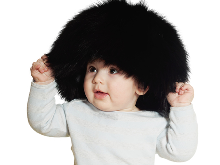 Caucasian baby boy in big black hat isolated on whiteの写真素材