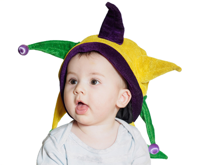 Caucasian baby boy wearing a colored party hat isolated on whiteの写真素材