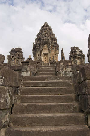 View up stone stairs, lined with imperial lions, towards the central tower of Bakong Temple  Part of Angkor complex, Cambodia   Ancient Khmer temple, hundreds of years old の写真素材
