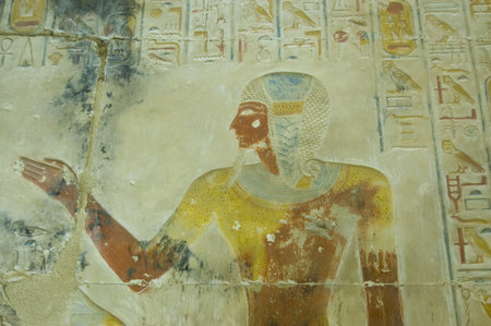 Ancient Egyptian bas relief  of the Pharaoh Seti I wearing the leopard skin of a High Priest   Wall of Abydos Temple near el Balyana, Egypt  Ancient temple on view to the public for over 2000 yearsのeditorial素材