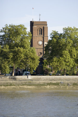 View across the River Thames at Battersea looking towards Chelsea Old Church, London   Historic church, housing the private chapel of Thomas More with parts dating to the 13th century のeditorial素材