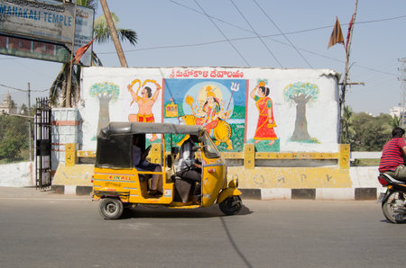 HYDERABAD, ANDHRA PRADESH, INDIA - JANUARY 12  An auto taxi passes the entrance of a Hindu Temple in...