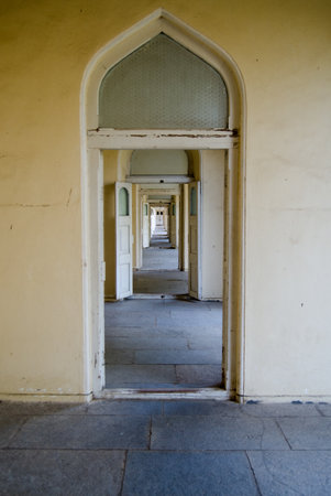 A long corridor with open doors leading through the historic Chowmahalla Palace in Hyderabad   Built...
