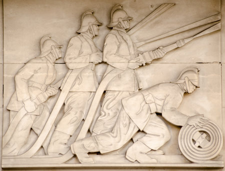 Art Deco bas relief sculpture showing fire fighters directing hoses at a blaze   On public display since 1937, sculpted by Gilbert Bayes  1872 - 1953    London Fire Brigade Headquarters, London のeditorial素材