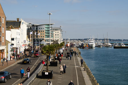 POOLE, DORSET, ENGLAND - MARCH 2  pedestrians strolling along the quay beside Poole Harbour on March 2 2013   The town attracts many visitors because of its marine facilities のeditorial素材
