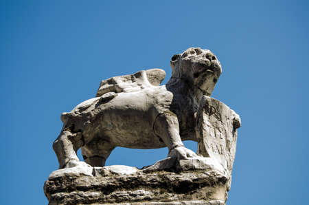 Weather damaged stone carving of a winged lion, the symbol of Venice   Island of Murano, Venice, Italy の写真素材