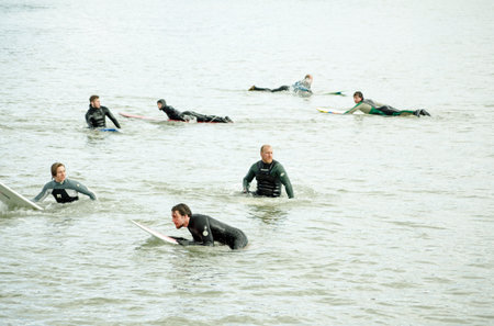 BOURNEMOUTH, ENGLAND - MARCH 1, 2014   Surfers floating in the sea waiting for a large wave, Bournemouth, Dorset   The resort is popular with surfers のeditorial素材