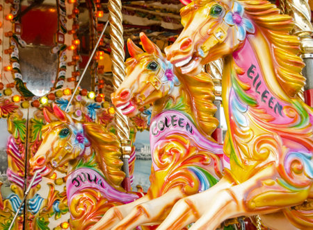 BOURNEMOUTH, ENGLAND - MARCH 1, 2014   Brightly painted steam galloper horses on a merry-go-round carousel のeditorial素材