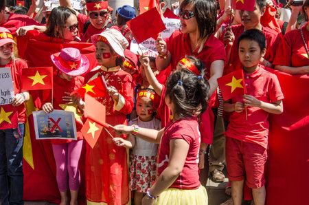 LONDON, ENGLAND - MAY 18, 2014  Children dressed in Vietnamese colours protesting outside the Chinese embassy against the move of an oil rig to contested South China Sea waters のeditorial素材