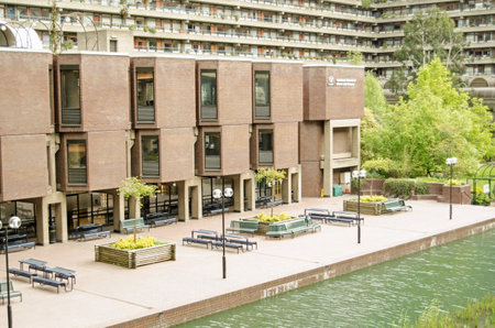 LONDON, ENGLAND - APRIL 12, 2014  View across the ornamental lake in the Barbican complex towards the Guildhall School of Music and Drama in the City of London のeditorial素材