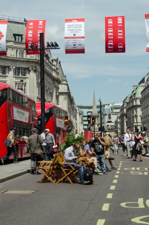 LONDON, ENGLAND - JUNE 22, 2014  Pedestrians making the most of a traffic-free Regent Street in the centre of London   The road was closed to vehicles as part of the Cavalcade of the Bus celebrations のeditorial素材
