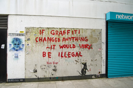 LONDON, ENGLAND - MAY 17, 2014  Some amusing graffiti by the British artist Banksy painted on the side of a wall in Westminster, Central London   Public work of art viewed from pavement のeditorial素材