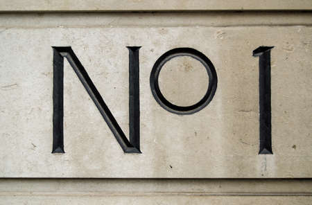 Sign for number one on the outside of an office block in central London の写真素材