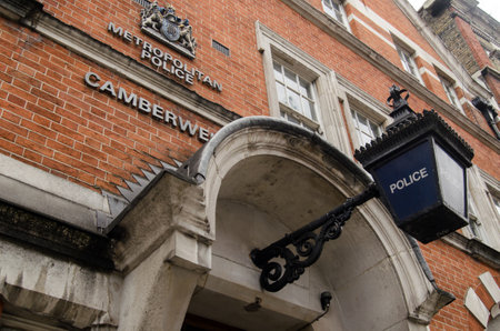 LONDON, UK - JUNE 16, 2014   Traditional blue lamp outside the entrance to Camberwell Police Station, Southwark, South London のeditorial素材