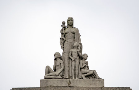 LONDON, UK  JUNE 16, 2014   Public statue of a woman holding the rod of Aesculapius and three children at various stages of childhood  The symbol of medicine and healing is above the Walworth Clinic, part of the National Health Service in Southwark, Southのeditorial素材