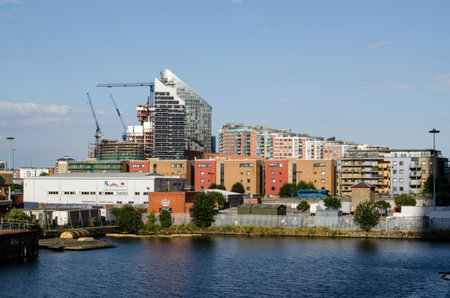 LONDON, UK  JULY 1, 2014  View across North Dock towards housing in Poplar, Tower Hamlets on the edge of London Docklands のeditorial素材