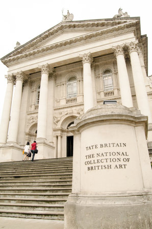 LONDON, UK - JULY 6, 2014:  Two visitors walking up the grand steps at the front of Tate Britain art...