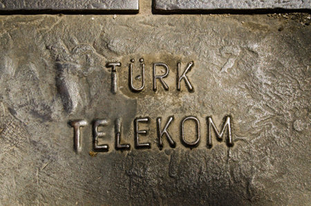 ANTALYA, TURKEY  AUGUST 18, 2014:  Metal cover in the pavement giving access to technology from Turk Telekom.  The telecommunications company used to be stateowned, but is now private.のeditorial素材
