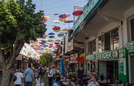ANTALYA, TURKEY - AUGUST 18, 2014:  An attractive bazaar in the centre of Antalya old town full of cafes and restaurants with umbrellas providing much needed shade in the August sunshine.のeditorial素材