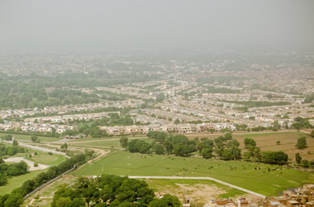 View from above of the city of Lahore with livestock in a field.  Pakistan.のeditorial素材