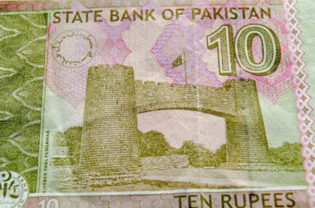 The Khyber Pass Gateway (Baab e Khyber; Bab-al-Khyber; Bab-el-Khyber) on Jamrud Road in Yaghistan near Peshawar. Used ten rupee banknote from Pakistan.  Less than 80% of note showing.の写真素材