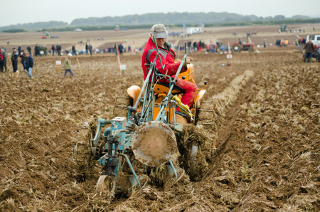 BASINGSTOKE, UK  OCTOBER 12, 2014: David Eastley taking part  in the second day of the British National Ploughing Championships organised by the Society of Ploughmen.  Competing in the Crawler Tractor class on a Cletrac tractor.  Accredited photographerのeditorial素材
