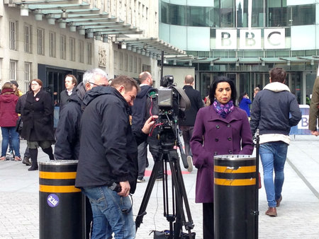 LONDON, UK - MARCH 25, 2015:  ITN reporter Nina Nannar covering the sacking of Jeremy Clarkson for punching a producer on Top Gear.  BBC Broadcasting House headquarters, London.のeditorial素材