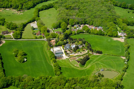 View from an airplane of expensive homes and farmland at Russ Hill in Surrey close to Gatwick Airport in countryside.の写真素材