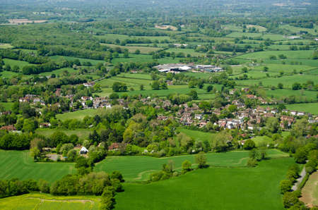 View from an airplane of the village of Charlwood inthe Surrey Hills.  A game of cricket is being played in the May sunshine on the village pitch.の写真素材