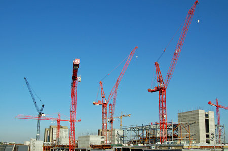 LONDON, UK - AUGUST 25, 2007: A forest of construction cranes building the huge Westfield Shopping Centre at Shepherd's Bush in West London. View on a sunny afternoon in August.のeditorial素材