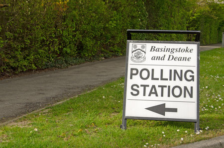 BASINGSTOKE, UK - MAY 5, 2016:  A sign pointing towards a polling station in the Hampshire borough of Basingstoke and Deane on election day.のeditorial素材