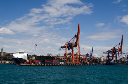 ISTANBUL, TURKEY - JUNE 8, 2016: Dockside cranes, anchored ships and containers at the quayside at...