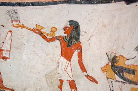 Ancient Egyptian mural showing a priest carrying an incense burner over a mummy.  Ancient Egyptian...