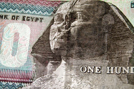 Detail of the one hundred pound banknote from the Egyptian Central bank showing the famous face of the Sphinx of Giza.  Used banknote photographed at an angleの写真素材