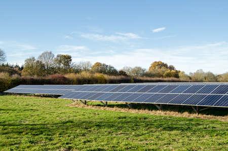 A field full of photovoltaic panels to generate solar energy in Hampshire, England.  Viewed from a...