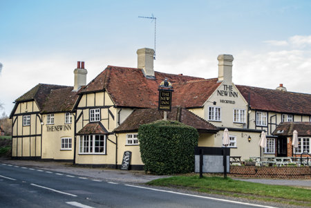 HECKFIELD, UK - MARCH 10, 2019: View of the historic coaching inn - The New Inn, Heckfield on the main Odiham to Reading road in Hampshire.  Dating back to Tudor times the Inn offers food, drink and accommodation.  Sunny spring afternoon.のeditorial素材