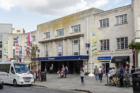 RICHMOND-UPON-THAMES, UK - SEPTEMBER 20, 2015: Pedestrians and traffic outside the busy railway...
