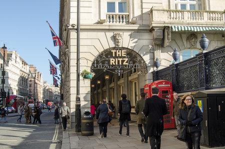 LONDON, UK - JANUARY 28, 2016:  Pedestrians and traffic at the Ritz Hotel arcade in Piccadilly, London on a sunny winter afternoon in central London.のeditorial素材