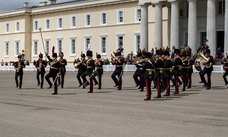 Sandhurst, Berkshire, UK - June 16, 2019: The Drum Major using his impressive mace to direct musicians of the Royal Artillery Band at a performance in front of Old College at the Sandhurst Military Academy on a summer day.のeditorial素材