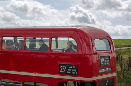 Wiltshire, UK - August 17, 2019: Sightseers on the top deck of a London bus in the military controlled Salisbury Plain. The bus route runs on only one day a year.のeditorial素材