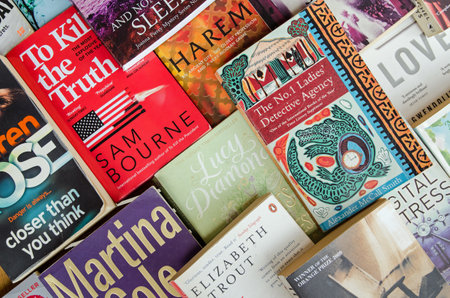 Castara, Trinidad and Tobago - January 12, 2020: Overhead view of a selection of popular paperback novels spread out on a table.のeditorial素材