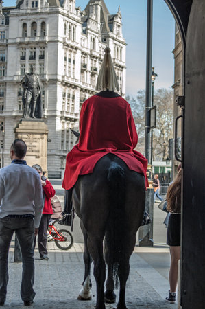 London, UK - March 25, 2012:  Tourists surrounding a mounted soldier at the famous Horseguard's Parade in Whitehall, Westminster.のeditorial素材