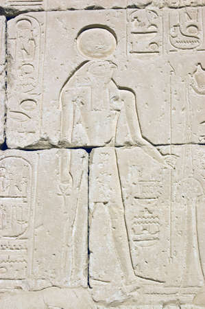 Stone carving of the Ancient Egyptian god Horus on a wall of the Temple of Pharoah Seti I on the West Bank of the River Nile at Luxor, Egypt.の写真素材