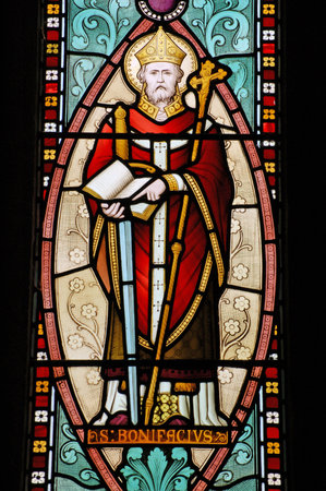 Victorian Stained glass window created in 1847 depicting the former patron saint of England Saint Boniface. A priest in the 8th century, he produced the first latin grammar in Englandのeditorial素材