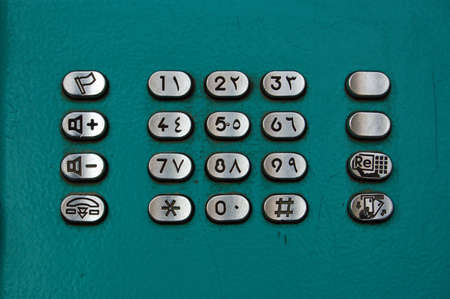 Push buttons on a public telephone in Egypt with both western and arabic numeralsの写真素材