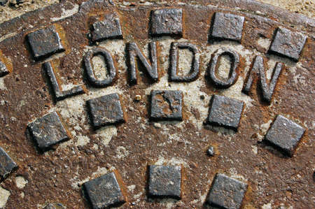A cast iron man hole cover with 'London' embossed on it.の写真素材