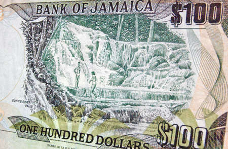 The reverse of a one hundred dollar banknote from Jamaica showing the country's famous Dunns River Falls where thermal springs form a natural landmark.の写真素材